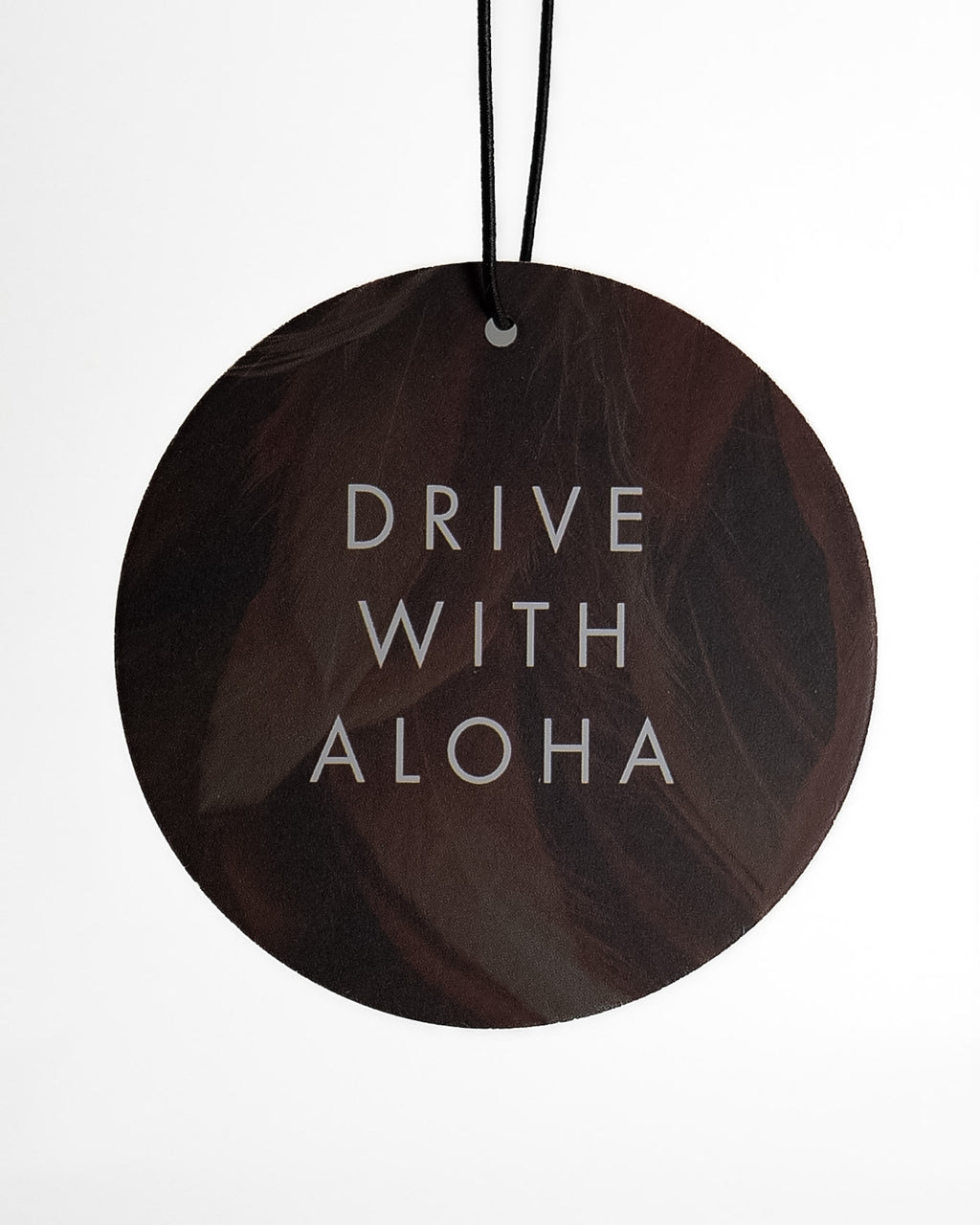 Round car freshener with 'Drive With Aloha' text on a white background