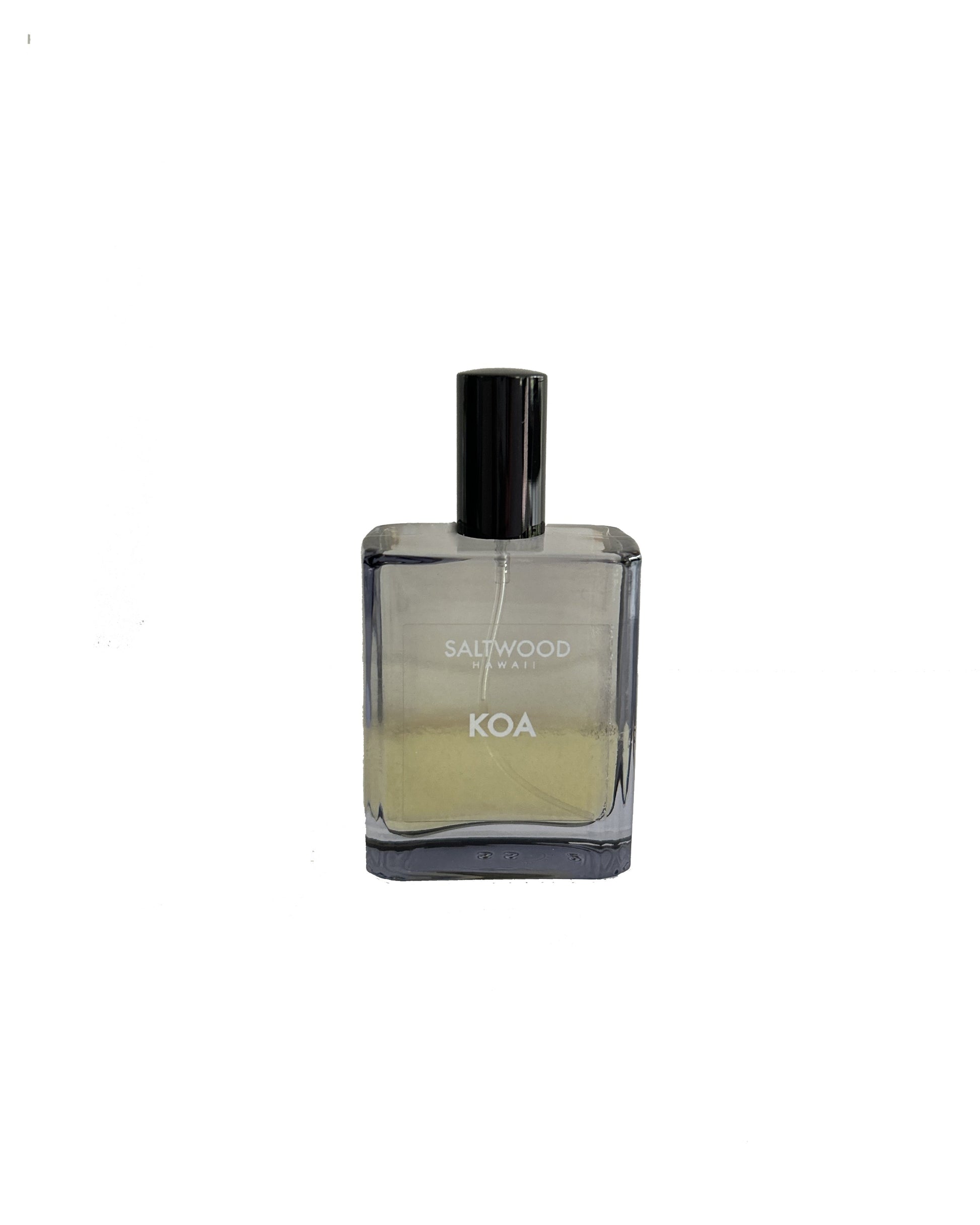 A bottle of Koa cologne with a clear liquid visible inside, labeled with the brand name 'KOA' on the front