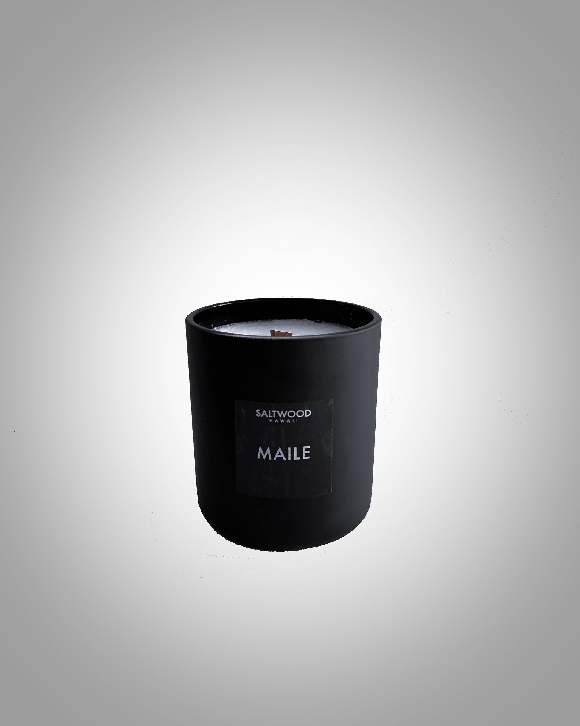 An 8 oz candle with a black lid and label that reads 'MAILE', placed against a light background.